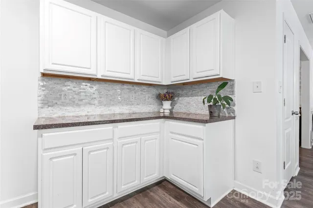 a kitchen with white cabinets and white appliances