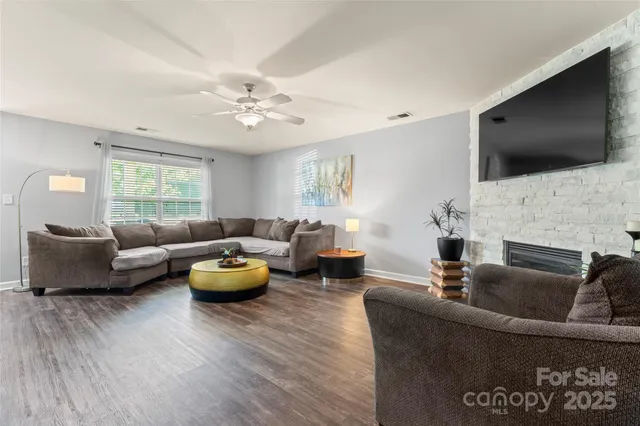 a living room with furniture fireplace and flat screen tv