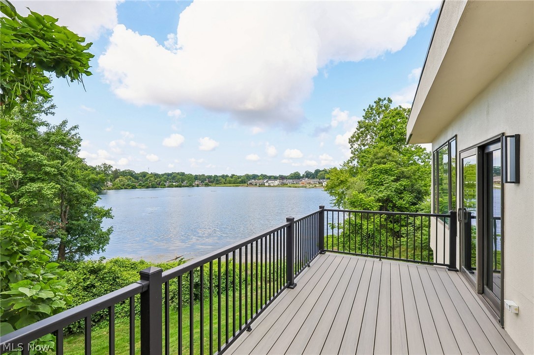 5490 Springlake Road Northwest Canton, OH 44718 - Photo 12 of 50 Lakefront deck featuring composite decking, black metal railings, and dual-pane glass doors