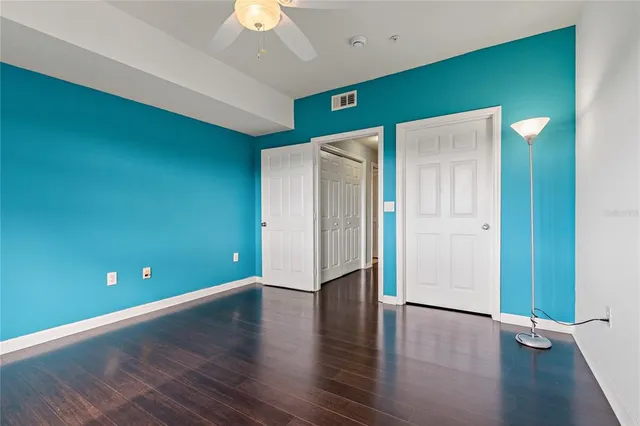 a view of an empty room with wooden floor