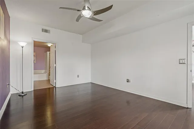 a bathroom with a granite countertop bathtub sink vanity mirror and toilet