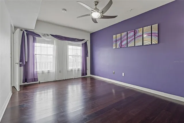 a white bath tub sitting next to a white toilet and vanity
