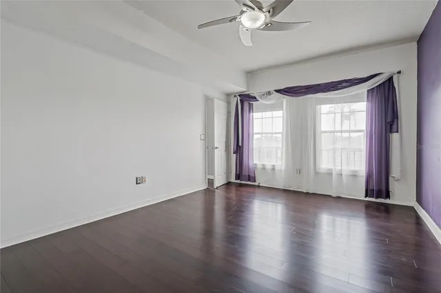 a bathroom with a granite countertop toilet sink and mirror