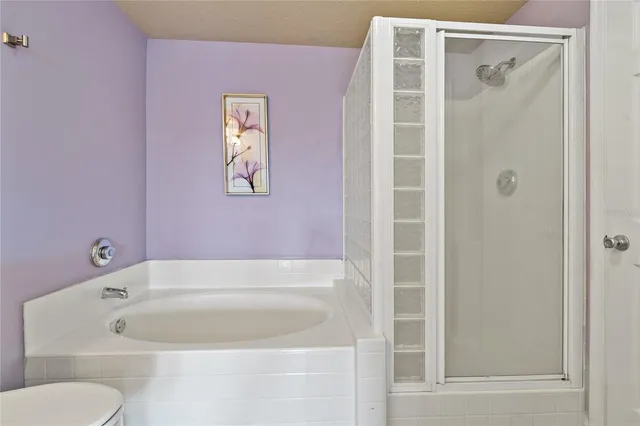 a view of a hallway with wooden floor and stairs
