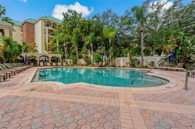 a view of a house with a yard and potted plants