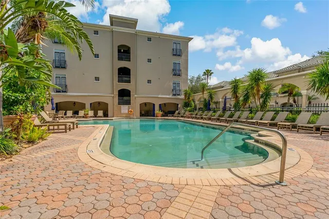 a front view of a house with a yard and potted plants
