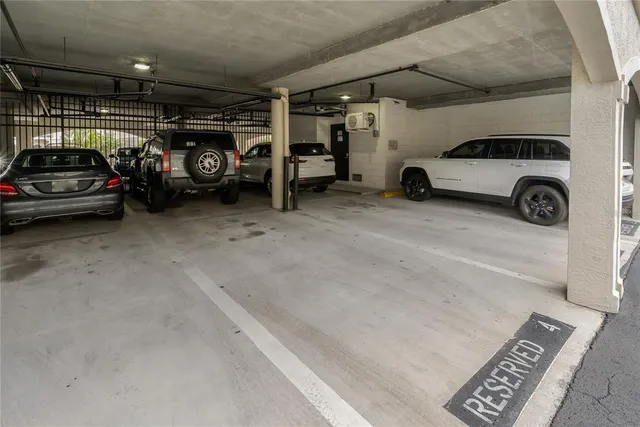 a view of parking garage with cars parked