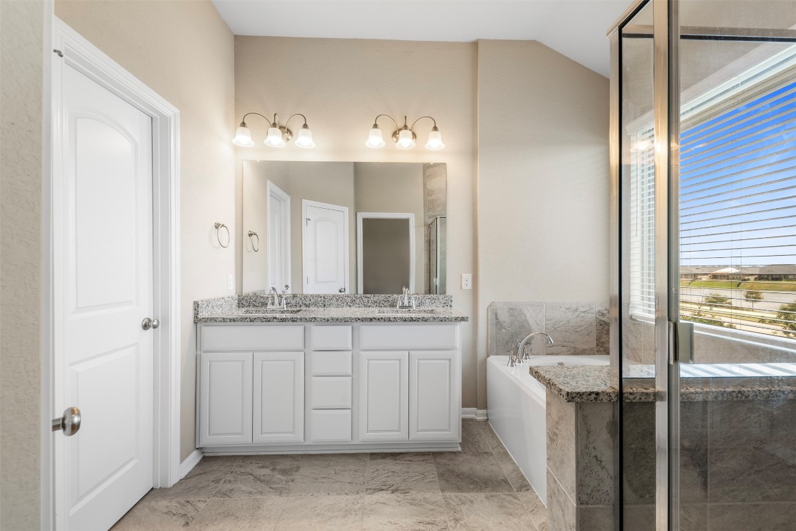 5203 Prairie Terrace Lane Fulshear, TX 77441 - Photo 16 of 32 a bathroom with a double vanity sink and a mirror