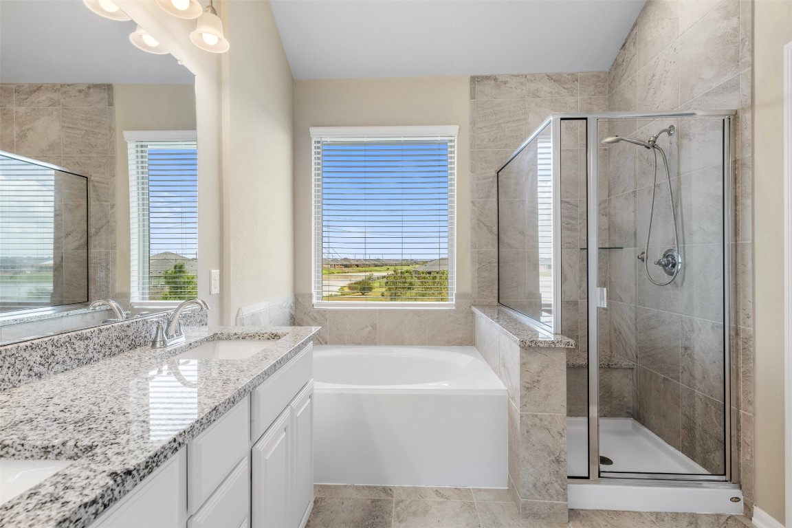 5203 Prairie Terrace Lane Fulshear, TX 77441 - Photo 17 of 32 a bathroom with a granite countertop tub shower and sink