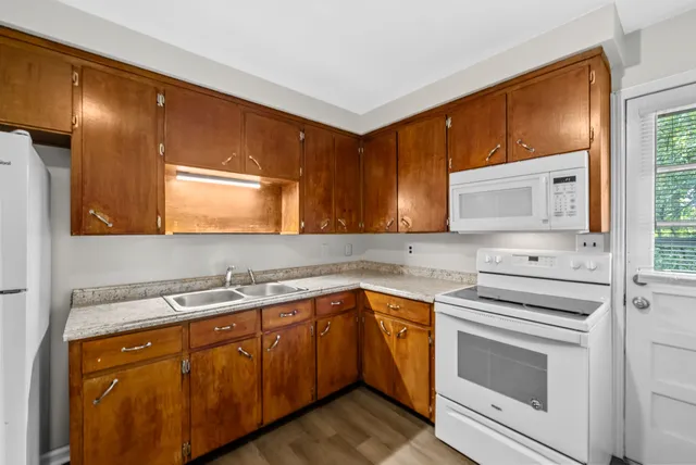 a kitchen with a sink stove and cabinets