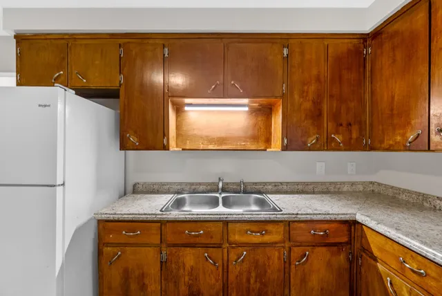 a view of a kitchen with a sink and cabinets