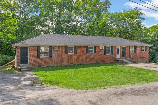 a aerial view of a house with a yard