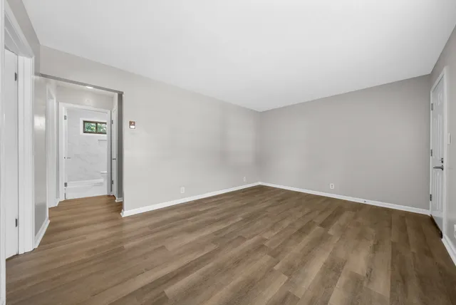 a view of an empty room and wooden floor