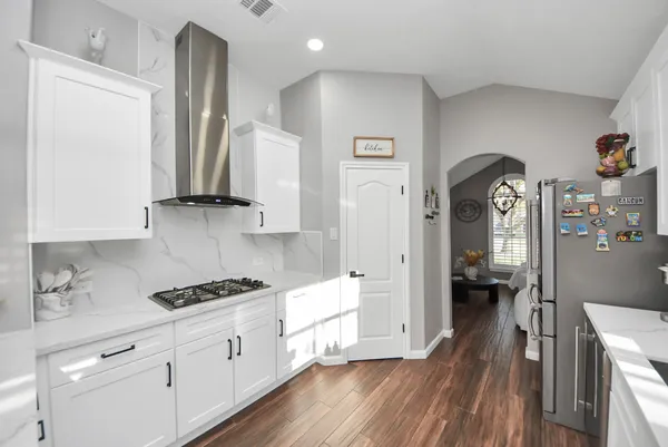a kitchen with sink cabinets and wooden floor