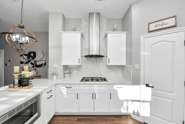 a kitchen with white cabinets and white appliances