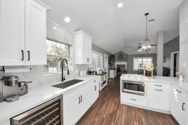 a kitchen with stainless steel appliances a sink stove and cabinets