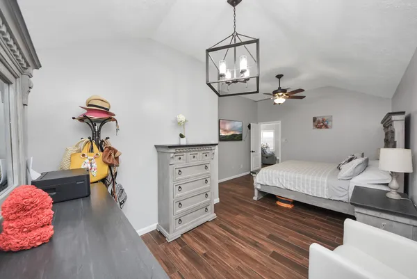 a bedroom with furniture and a chandelier