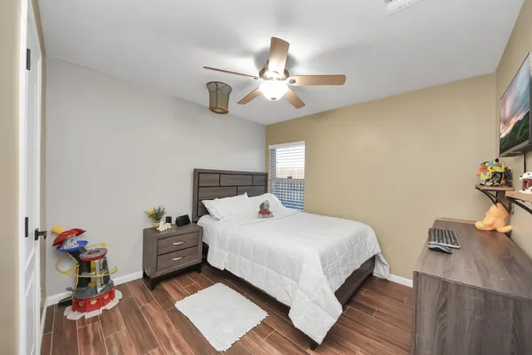 a bedroom with a bed and wooden floor