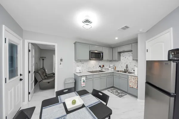 a kitchen with a sink appliances and cabinets