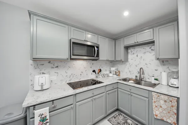 a kitchen with appliances cabinets and a sink