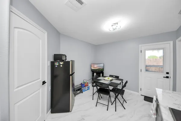 a view of a workspace with furniture and a window