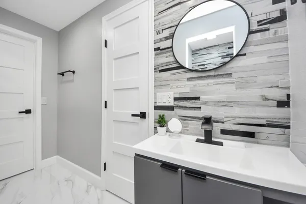 a bathroom with a sink and a mirror