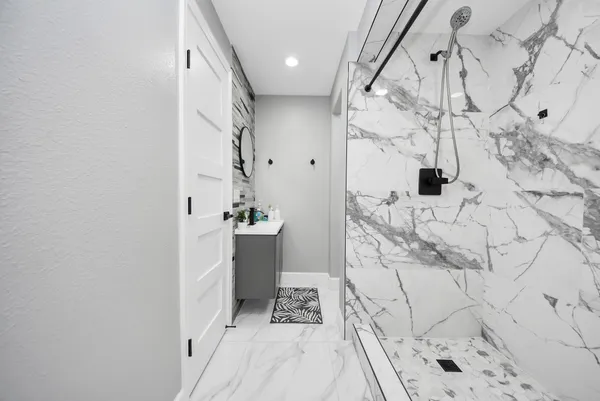 a bathroom with a bathtub and shower