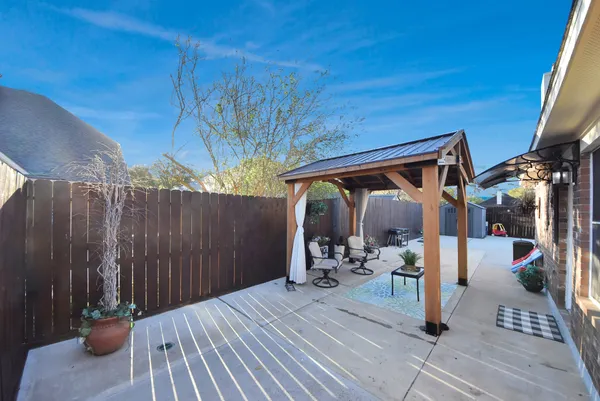 a view of a backyard with sitting area