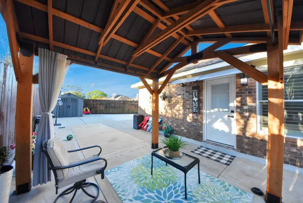 a view of patio with table and chairs and potted plants