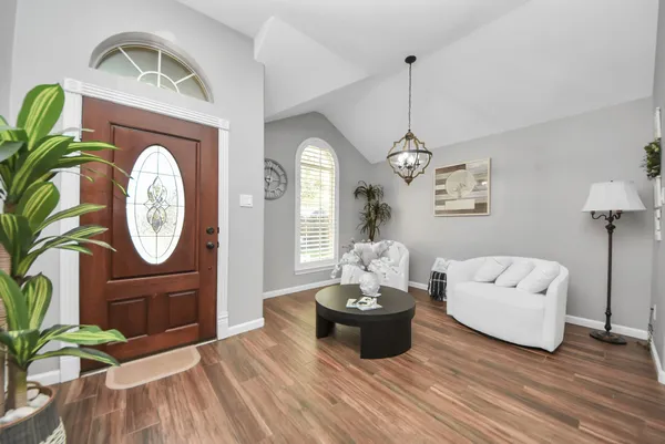 a living room with furniture and a chandelier