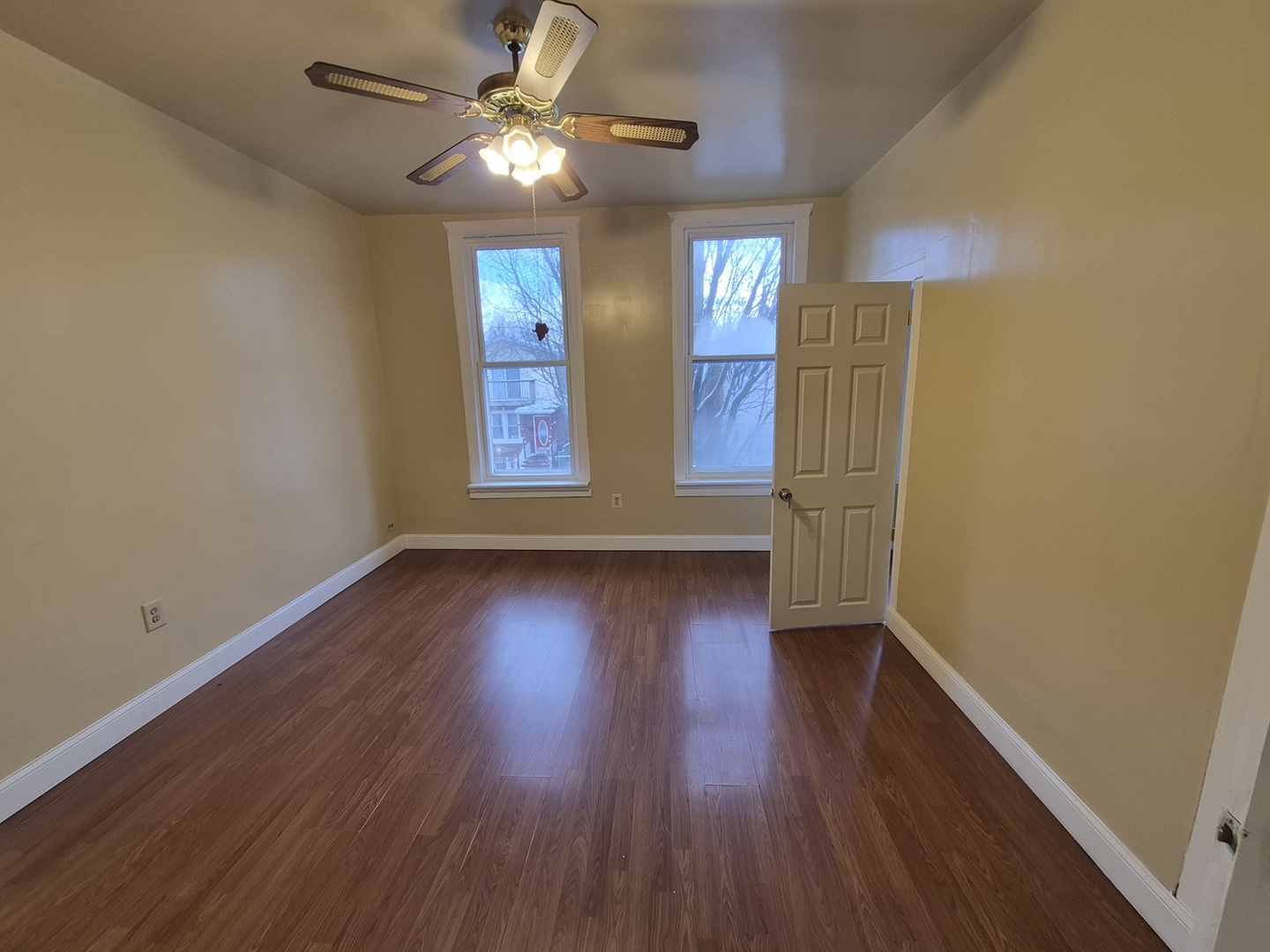 2046 West 19th Street, Unit 2 Chicago, IL 60608 - Photo 3 of 11 wooden floor in an empty room with a window