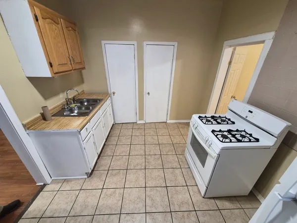 a kitchen with a stove a sink and a refrigerator