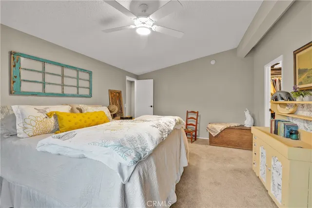 a spacious bedroom with a bed and a chandelier
