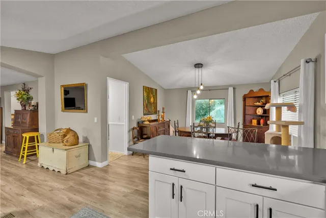 a bathroom with a sink a refrigerator a window and a shower