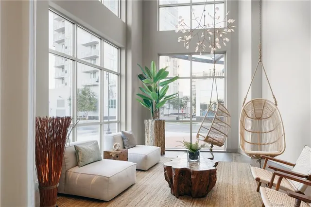 a living room with furniture and a potted plant