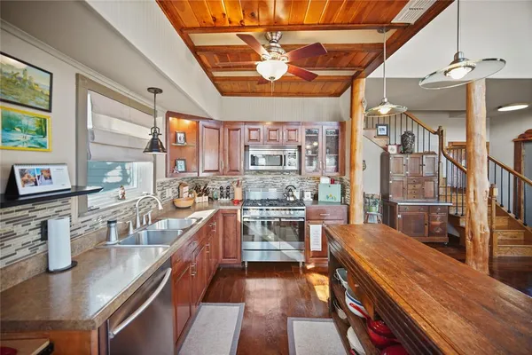 a kitchen with stainless steel appliances granite countertop a stove and cabinets