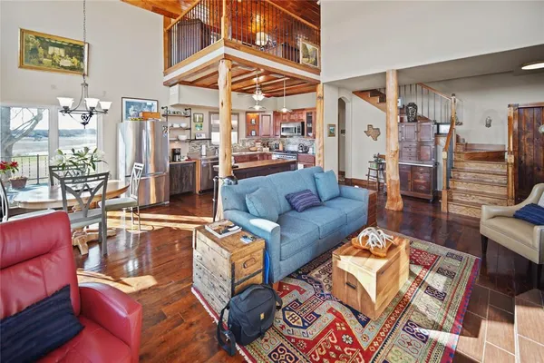 a living room with furniture a rug and a chandelier