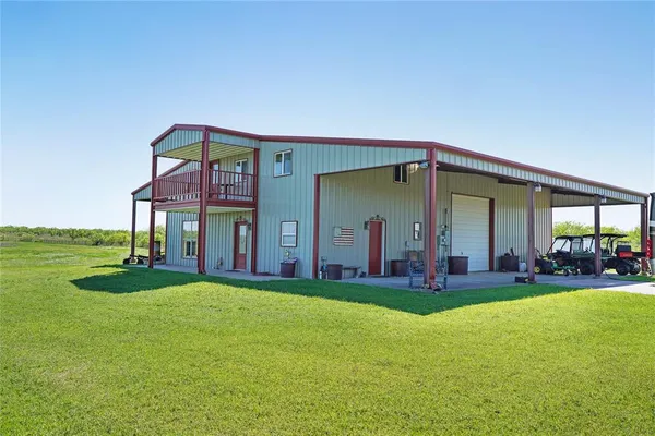 a view of a house with a yard and garage