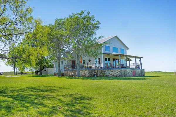 a view of a house with a yard porch and sitting area