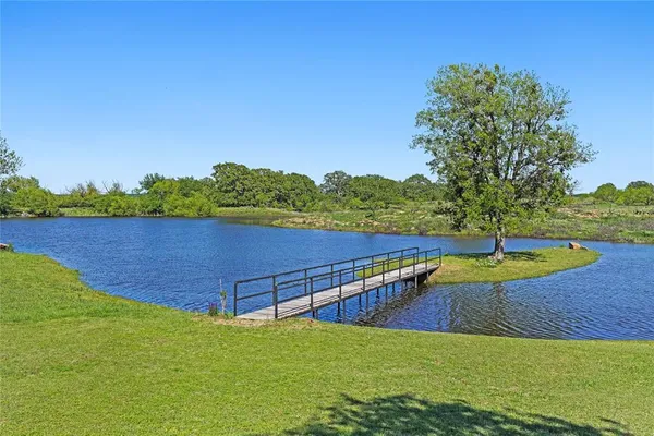 a view of a swimming pool with a yard