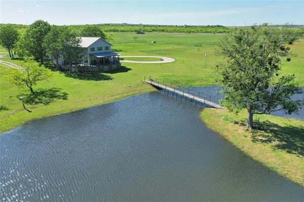 a view of a house with a yard and a swimming pool