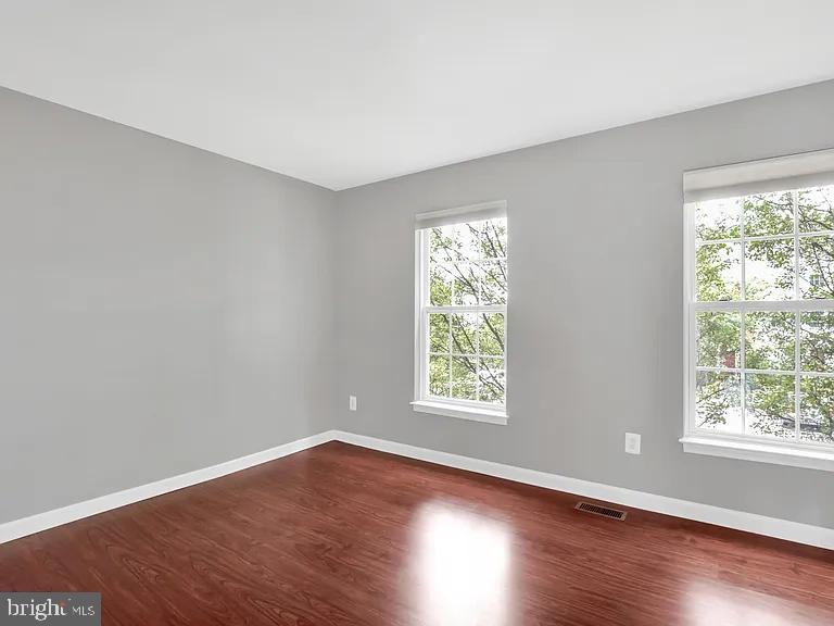 44480 Watertown Terrace Ashburn, VA 20147 - Photo 12 of 22 an empty room with wooden floor and windows