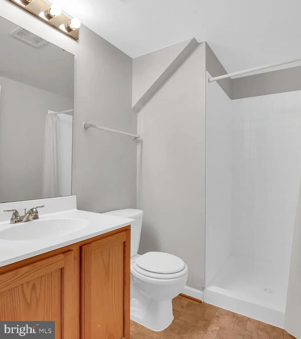 44480 Watertown Terrace Ashburn, VA 20147 - Photo 14 of 22 a bathroom with a sink a toilet and shower