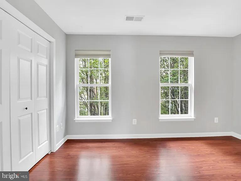 44480 Watertown Terrace Ashburn, VA 20147 - Photo 16 of 22 an empty room with wooden floor and windows