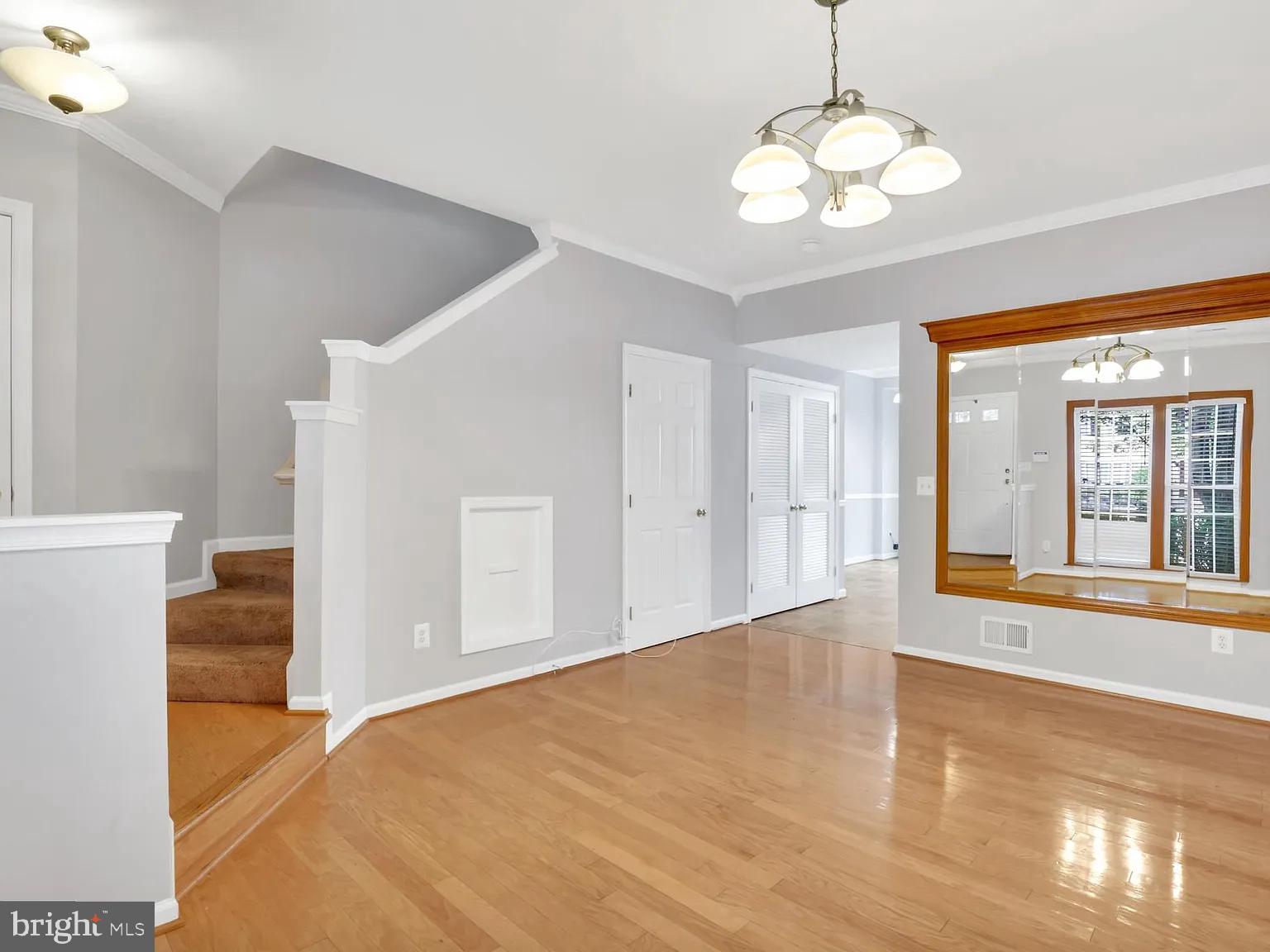44480 Watertown Terrace Ashburn, VA 20147 - Photo 2 of 22 a view of an empty room with wooden floor and a window
