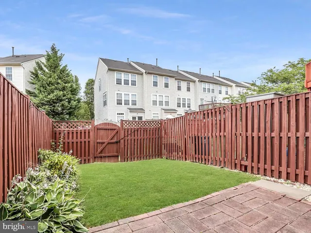 a view of a backyard with wooden fence