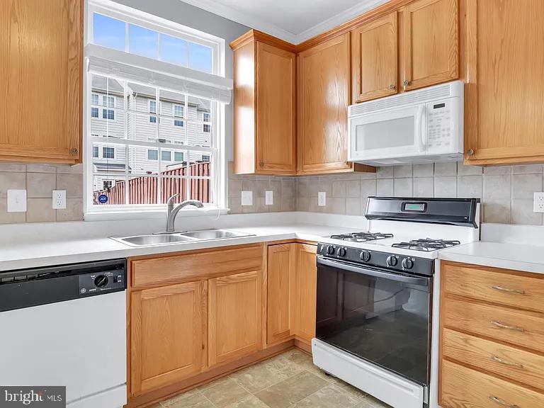 44480 Watertown Terrace Ashburn, VA 20147 - Photo 7 of 22 a kitchen with stainless steel appliances granite countertop a stove a sink and a microwave