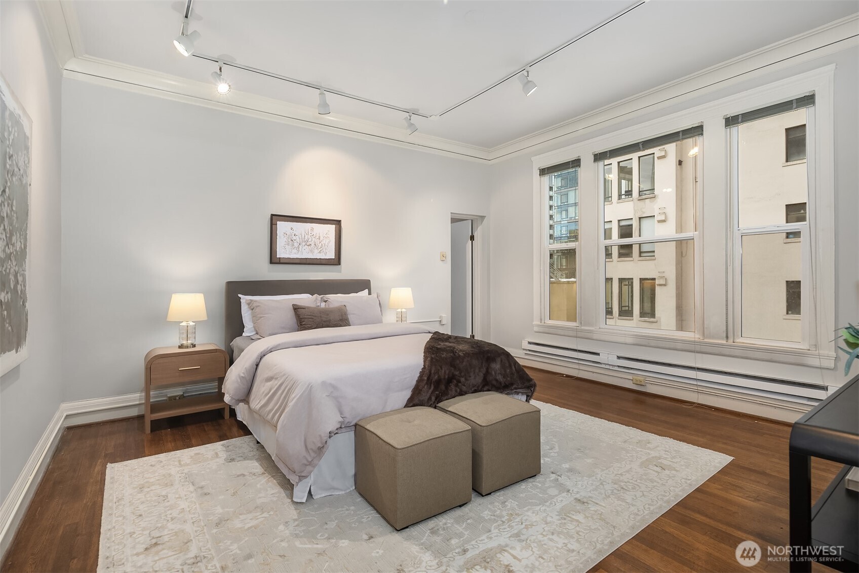 1519 3rd Avenue, Unit 801 Seattle, WA 98101 - Photo 23 of 40 a spacious bedroom with a bed couch and a window