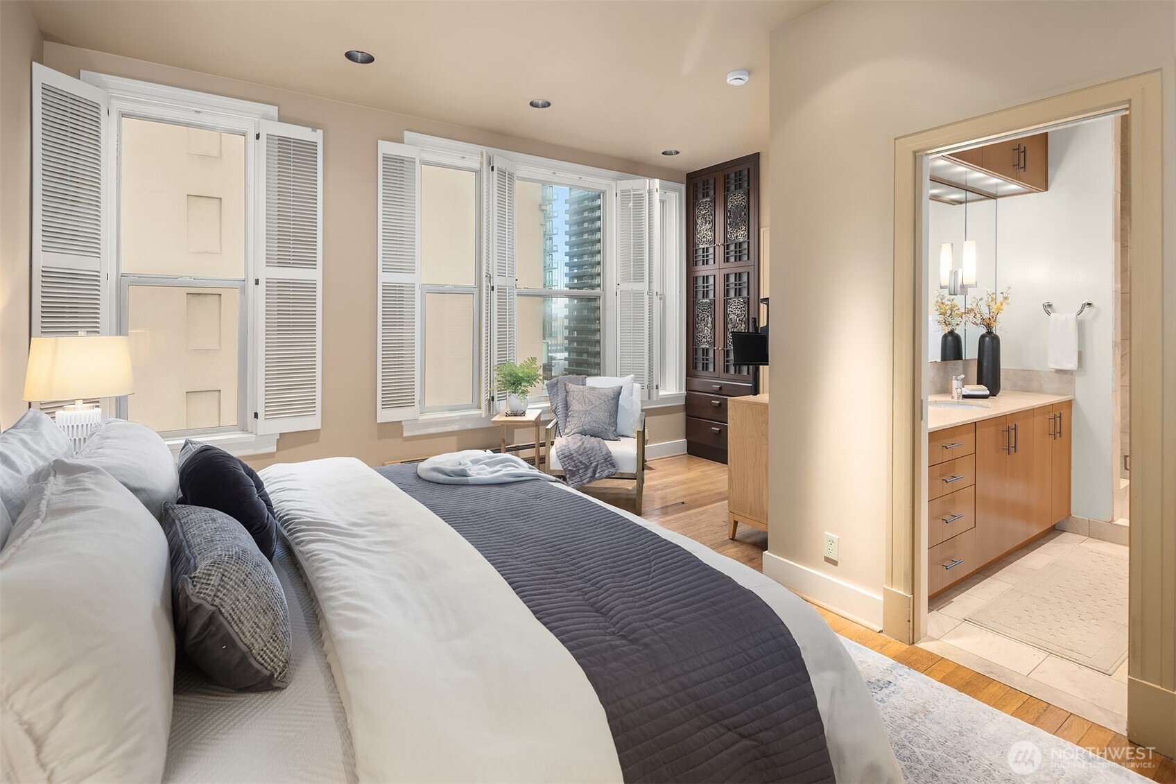1519 3rd Avenue, Unit 801 Seattle, WA 98101 - Photo 29 of 40 a spacious bedroom with a large bed and a large window