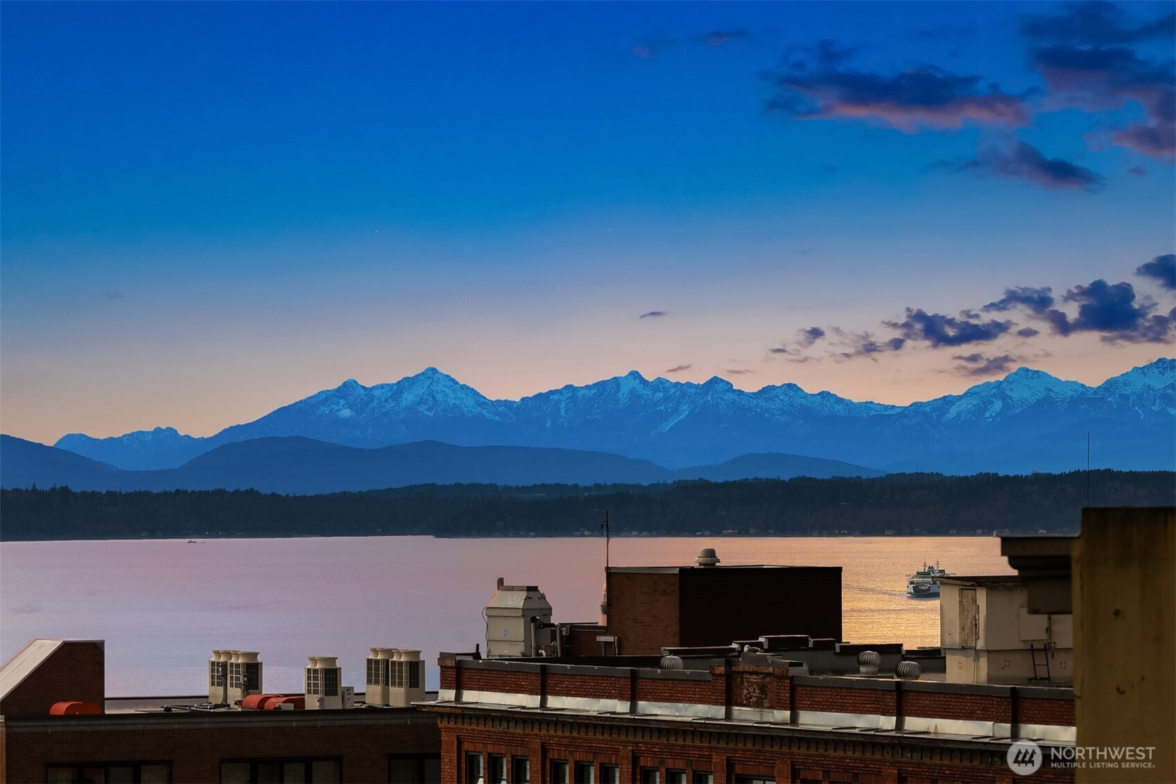 1519 3rd Avenue, Unit 801 Seattle, WA 98101 - Photo 37 of 40 a view of a city with sunset